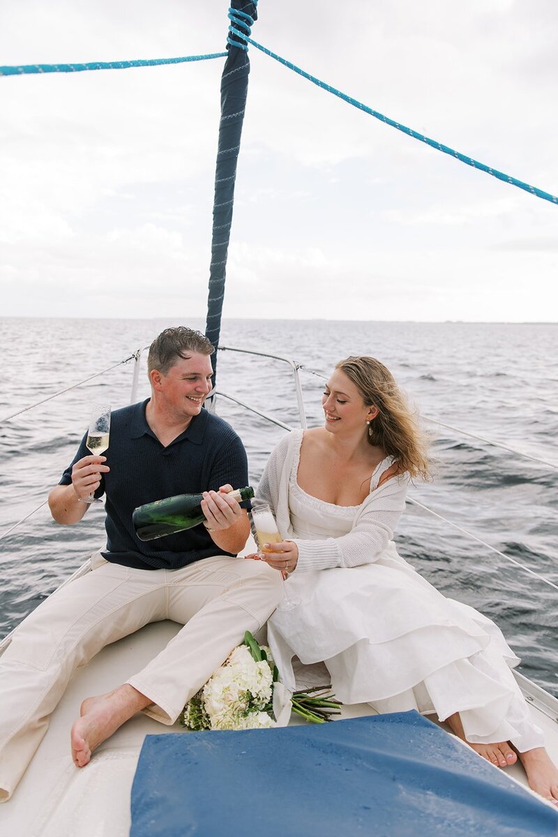 couple drinking champagne on boat by wedding planner south jersey