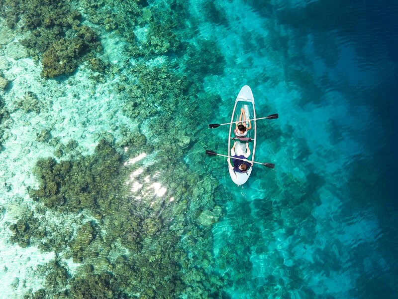 Image of an aerial view of kayakers over an ocean reef