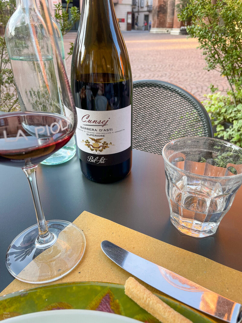 Outdoor dining with wine at La Piola in Alba, Italy