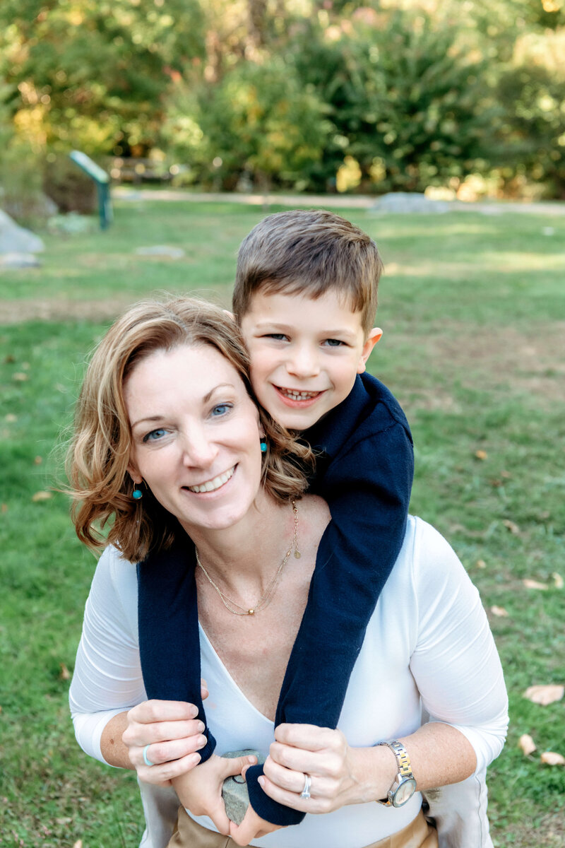 Connecticut Family Photographer captures a mom and son cuddling in a park