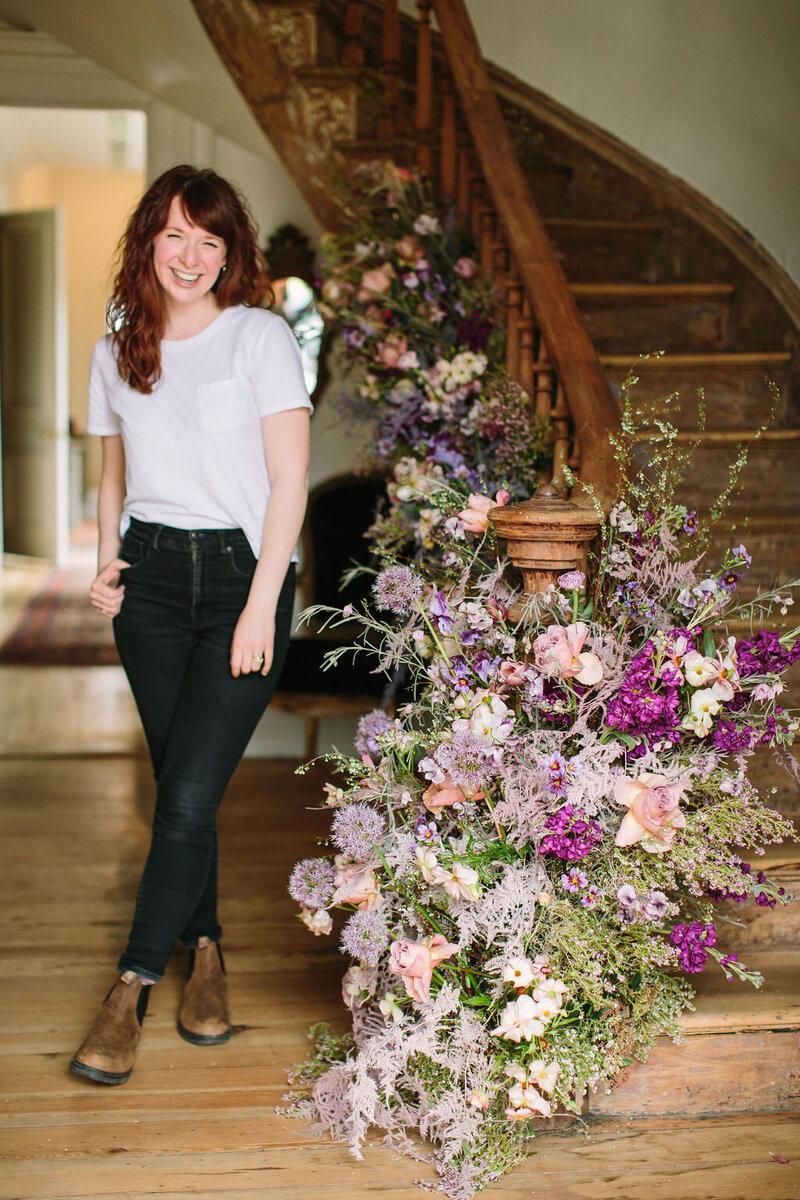 Mary Love Richardson, Rosemary and Finch floral design company owner and founder, wedding and event floral design in Nashville, TN and travel weddings. Staircase flowers in color shades of purple, lavender, cream, blush, sage, and magenta.
