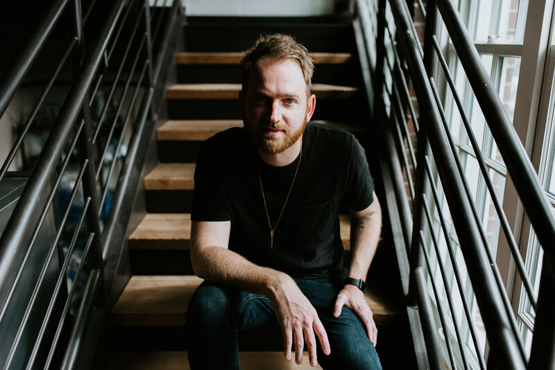 Musician sitting on stairs at Tinker House Events