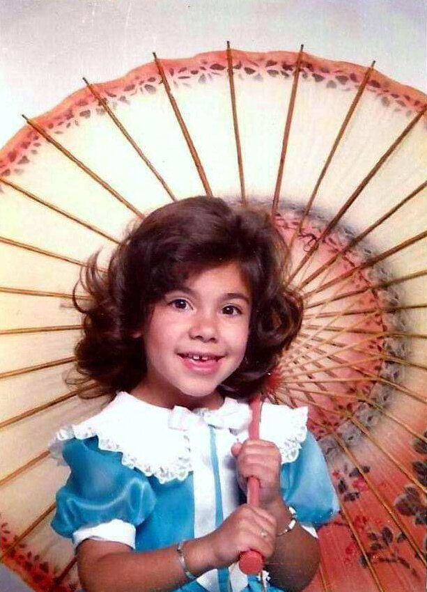 5 year old stef gass with large umbrella and blue dress