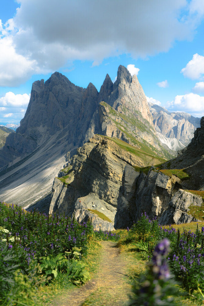 Seceda | a huge mountain ridge that ends in a sharp point and steep cliffs on both sides