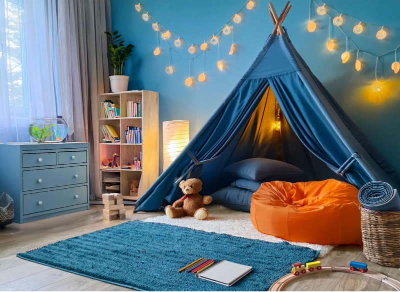 room with ambient soft lighting, cozy rugs, pillows, bean bag, stuffed toys, drawing materials, and building blocks