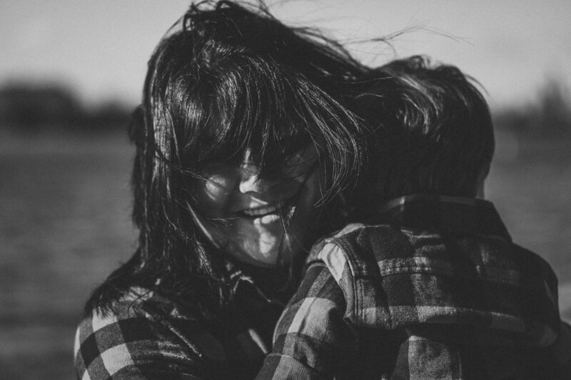 bnw mom holding child on a windy day