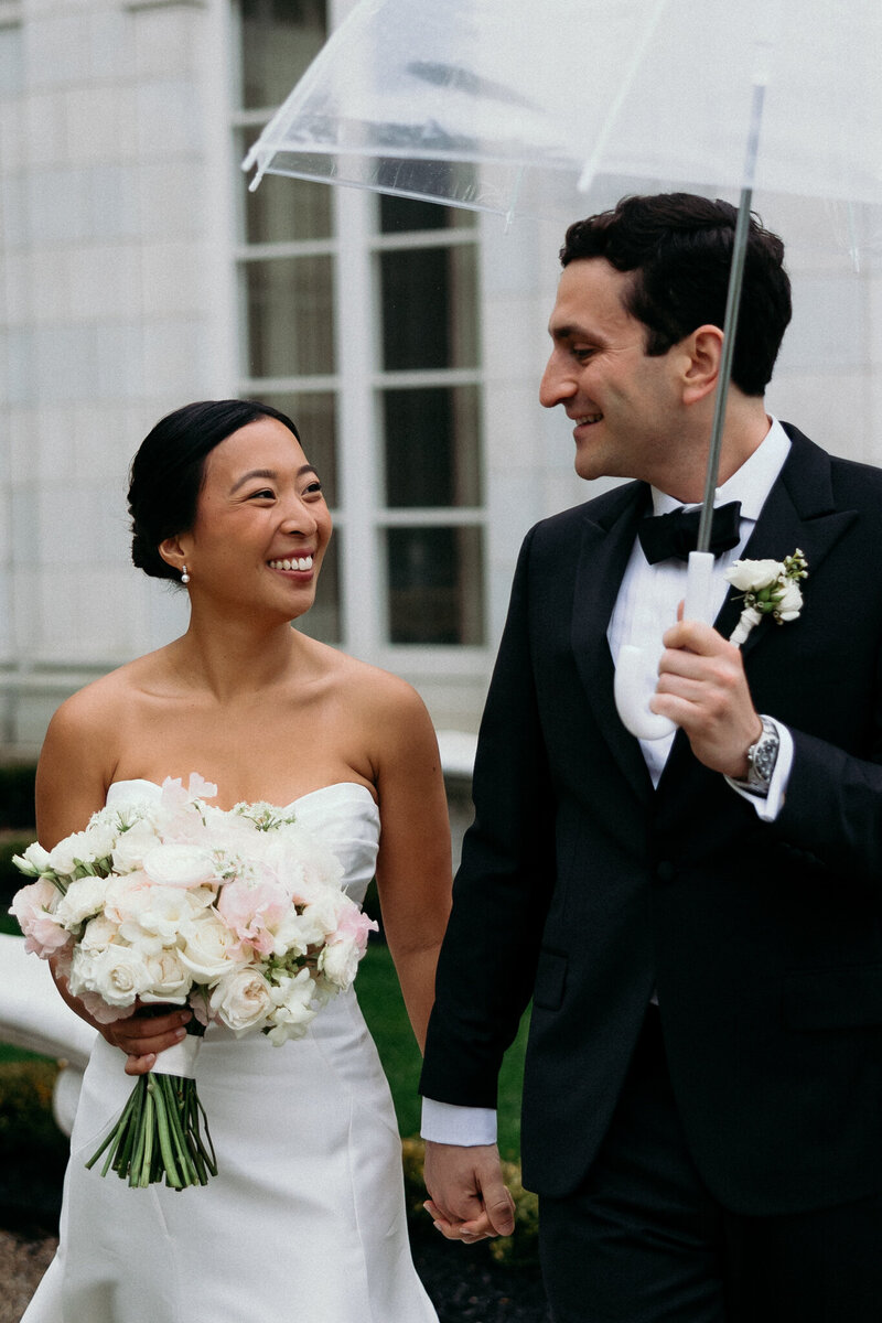 Vermont Wedding Photographer | Sincerely Liz Photography Documentary Wedding, Engagement, Elopement, Maternity and Newborn Photographer in New England | Bride smiling at groom as he  holds an umbrella