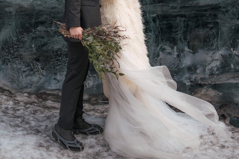 Bride and groom in a blue ice cave in Iceland, photographed by Kristen Vann, Virginia elopement photographer
