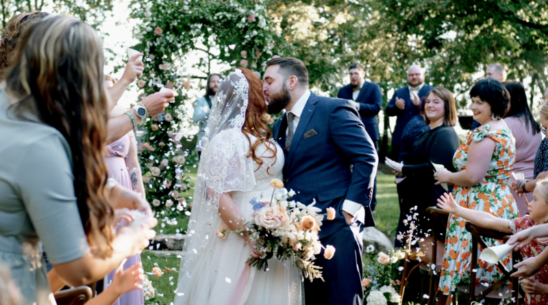 Bride and groom share their first kiss as husband and wife.