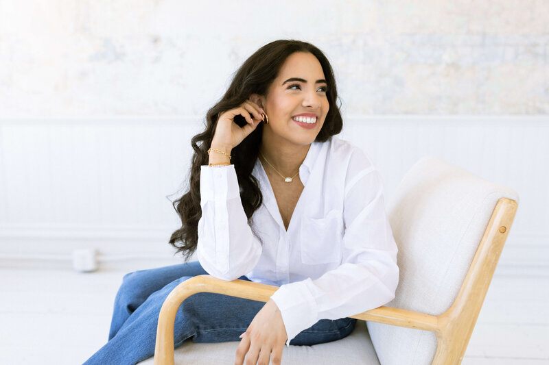 Girl with long dark hair posing in photo studio