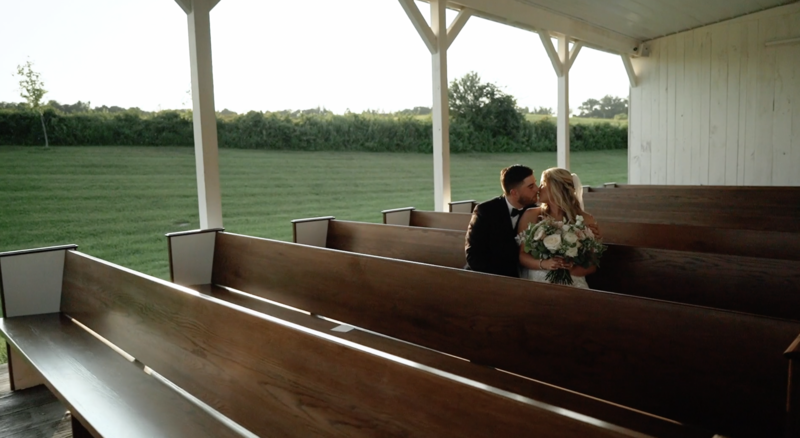 newlyweds kiss in pew