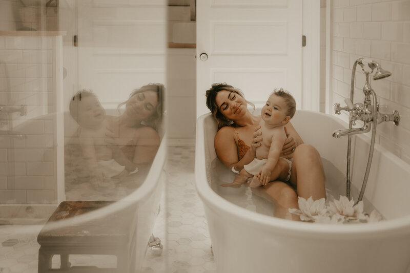 Newborn baby sleeping in a cozy knit outfit, gently cradled in a parent’s arms during a lifestyle newborn session in Metuchen, NJ, captured by Burkat Photography.