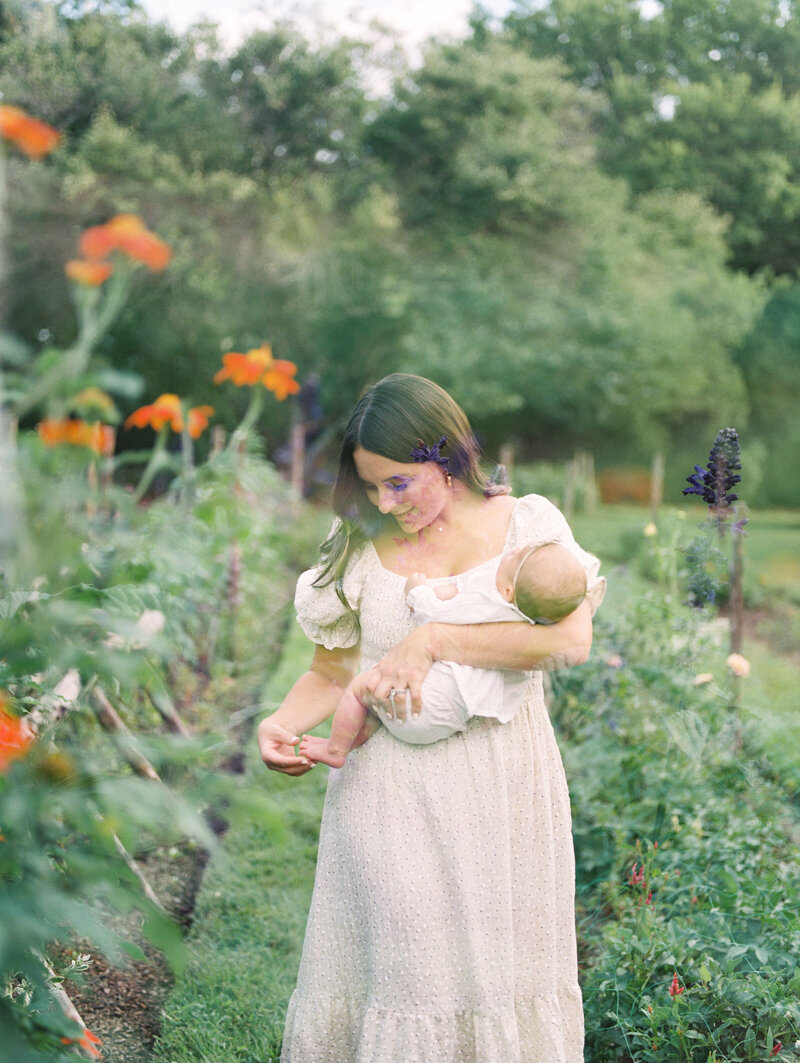 Double exposure of mother holding her baby in a flower garden