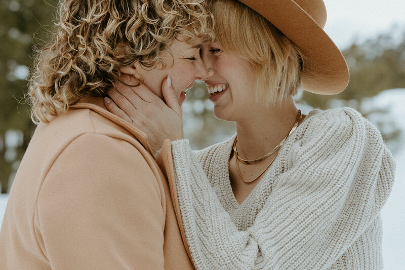 Man holds woman in snow