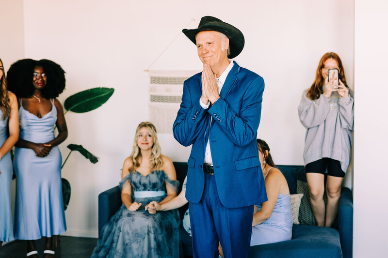 Father smiles emotionally at daughter  as she reveals her wedding dress for the first time winx photo tennessee wedding photographer