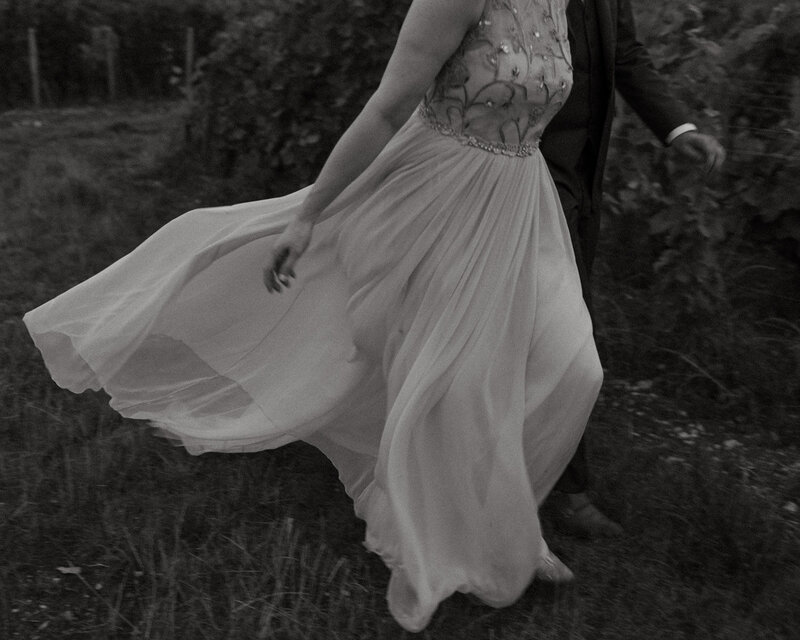 a bride's dress is blowing in the wind