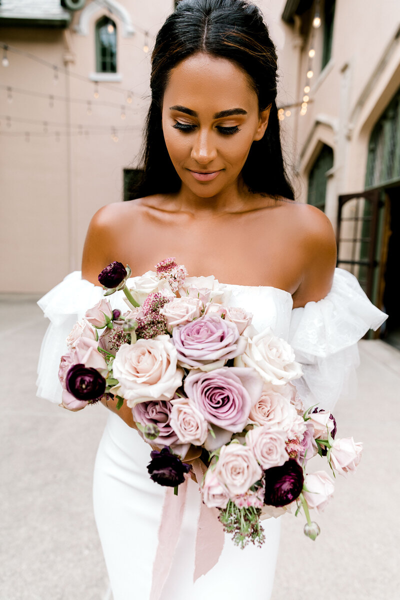 Bride with lavendar & purple rose bouquet at Fowler House Mansion