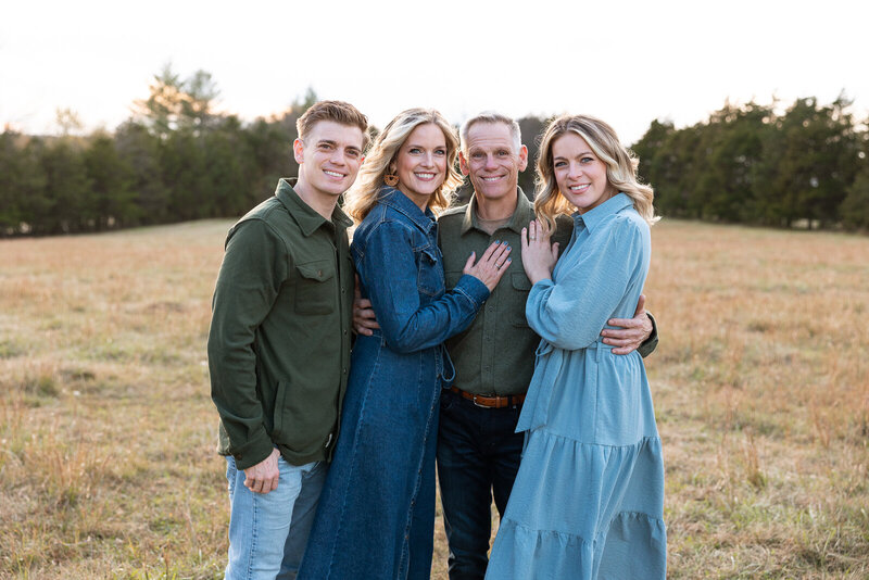 Family portrait of two parents with their adult children during an extended family portrait session. 