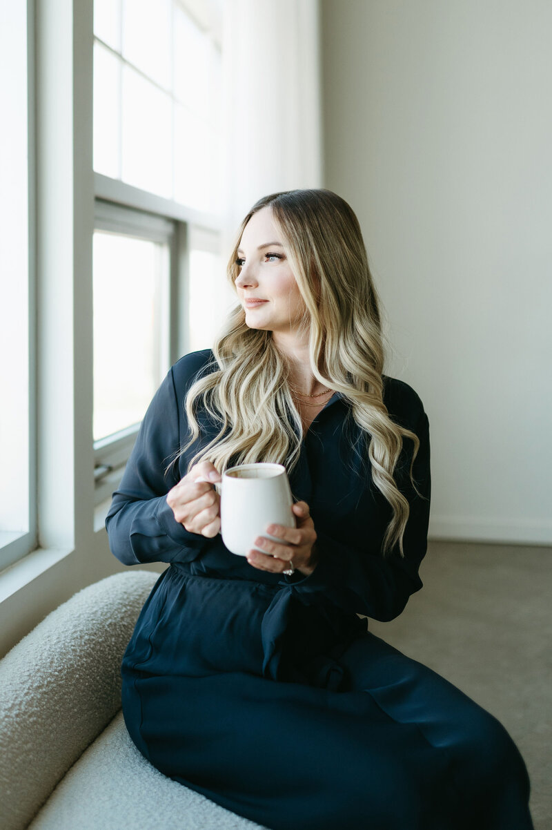 Karly Whitaker enjoying a coffee break while planning her next client's systems, automations, and HoneyBook workflows.