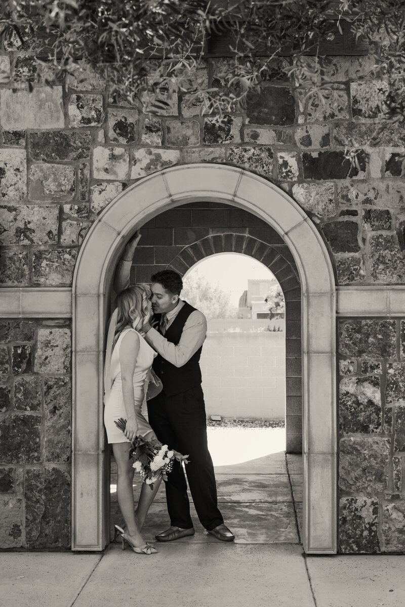 Couple Holding Each Other Under An Arch in Litchfield Arizona