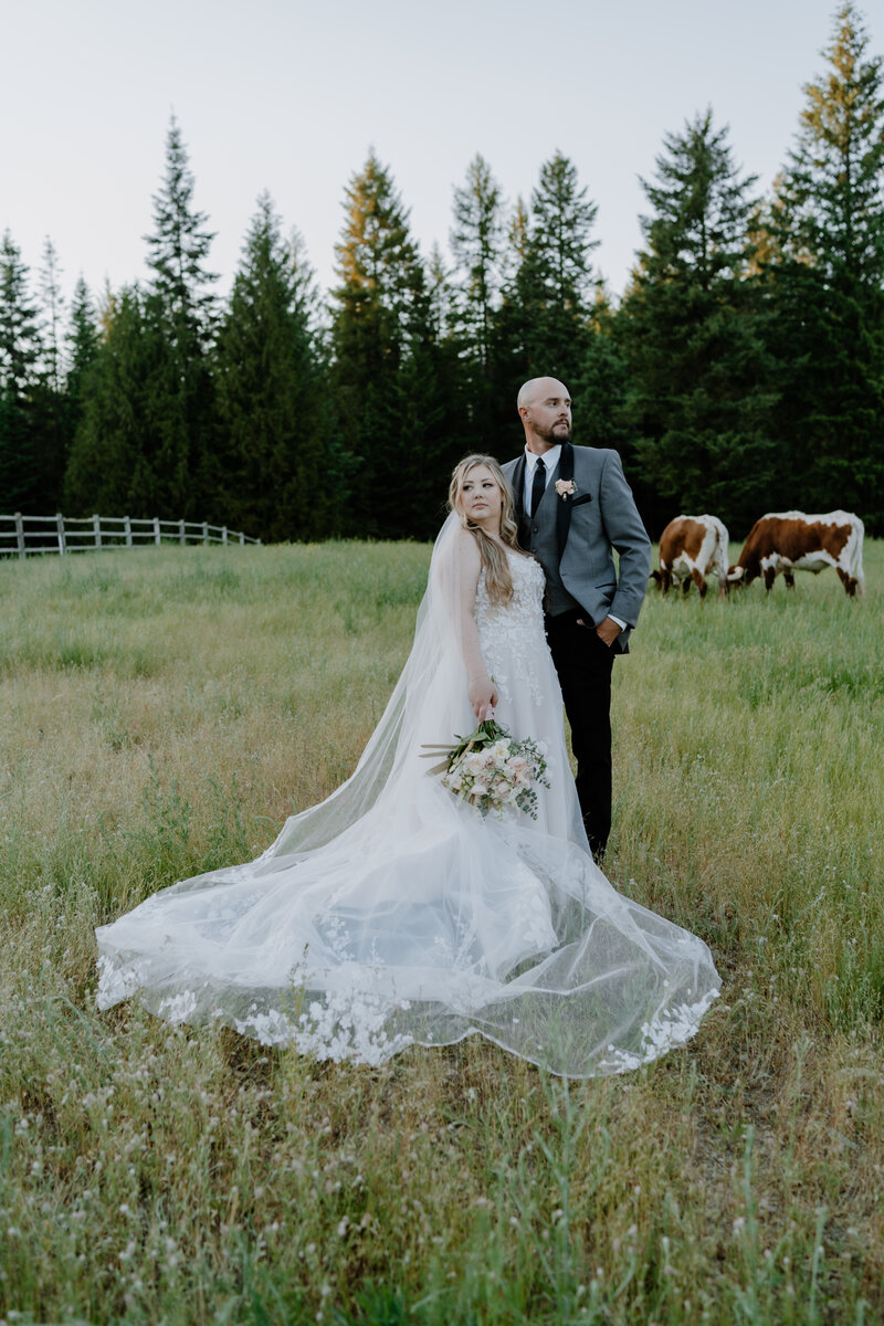 groom touching the bride's chin with his hand and they both touch foreheads with eyes closed