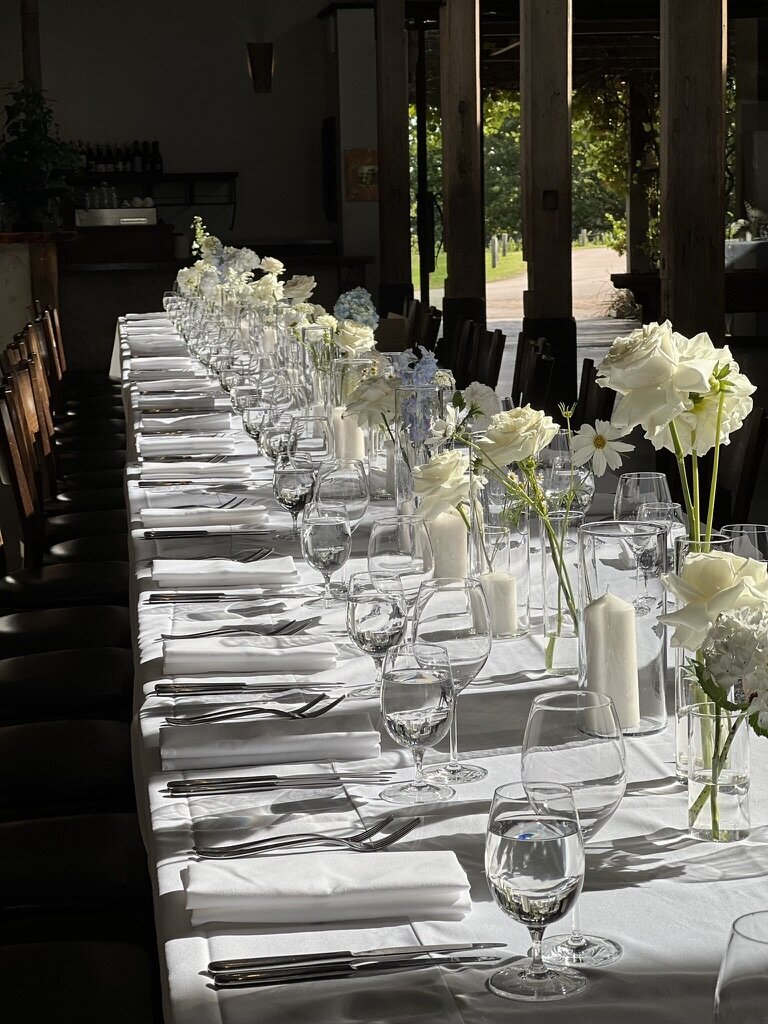 White and light blue bud vases along the table Sugar Bee Flowers