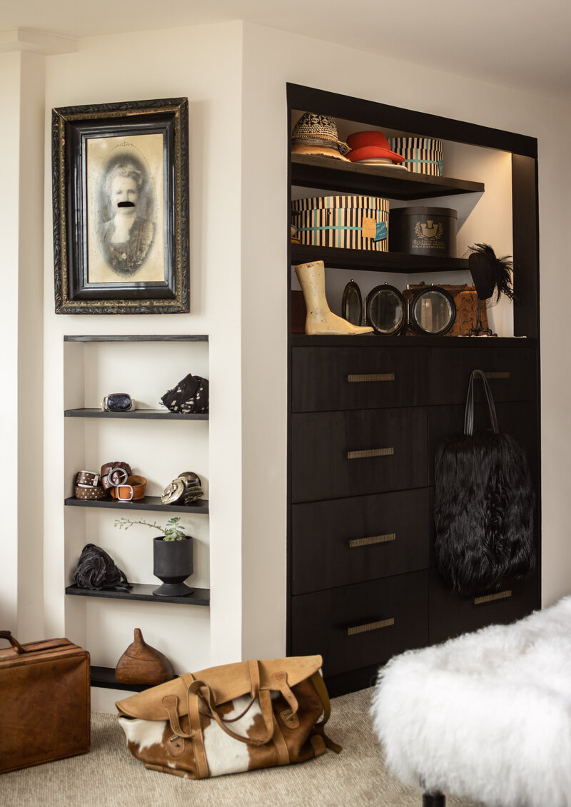 Interior design photography of a stylish closet with vintage decor and accessories.