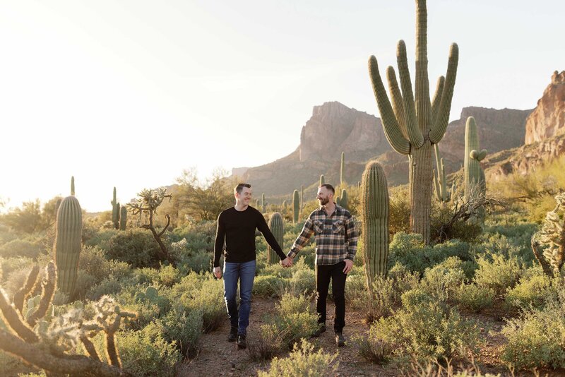 LGBTQ+ couple hold hands in the Phoenix desert.