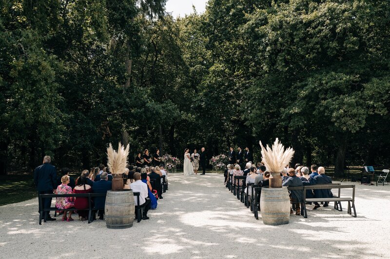 the ceremony area at bangor farm on white stones under trees on a summer day