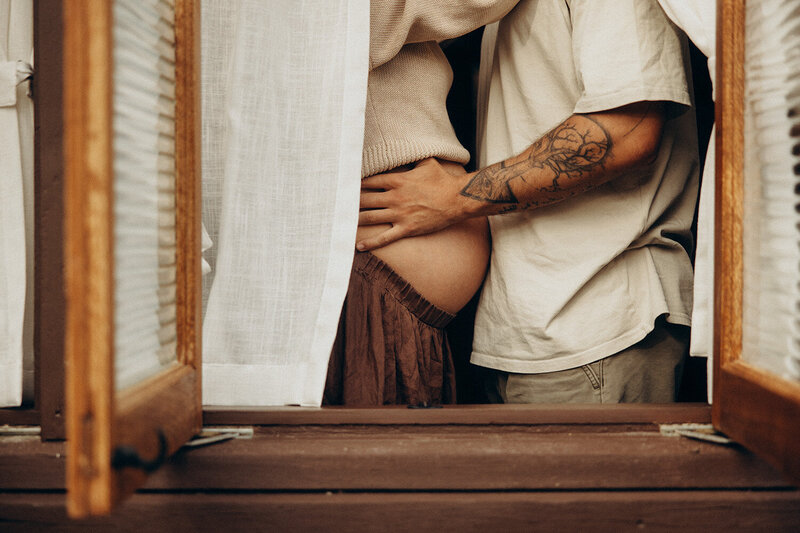 Couple during a maternity couples photoshoot close up cuddling,  by Nicci K Photography Sunshine Coast