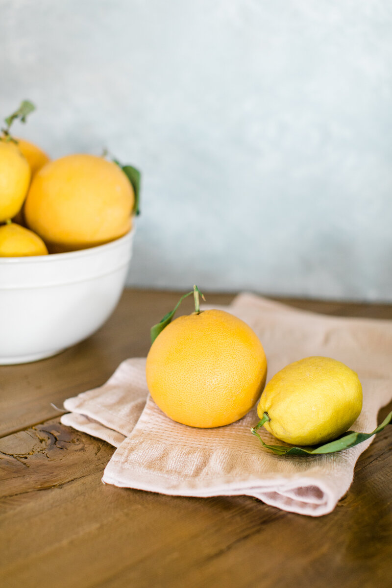 bright yellow lemons on a wooden table
