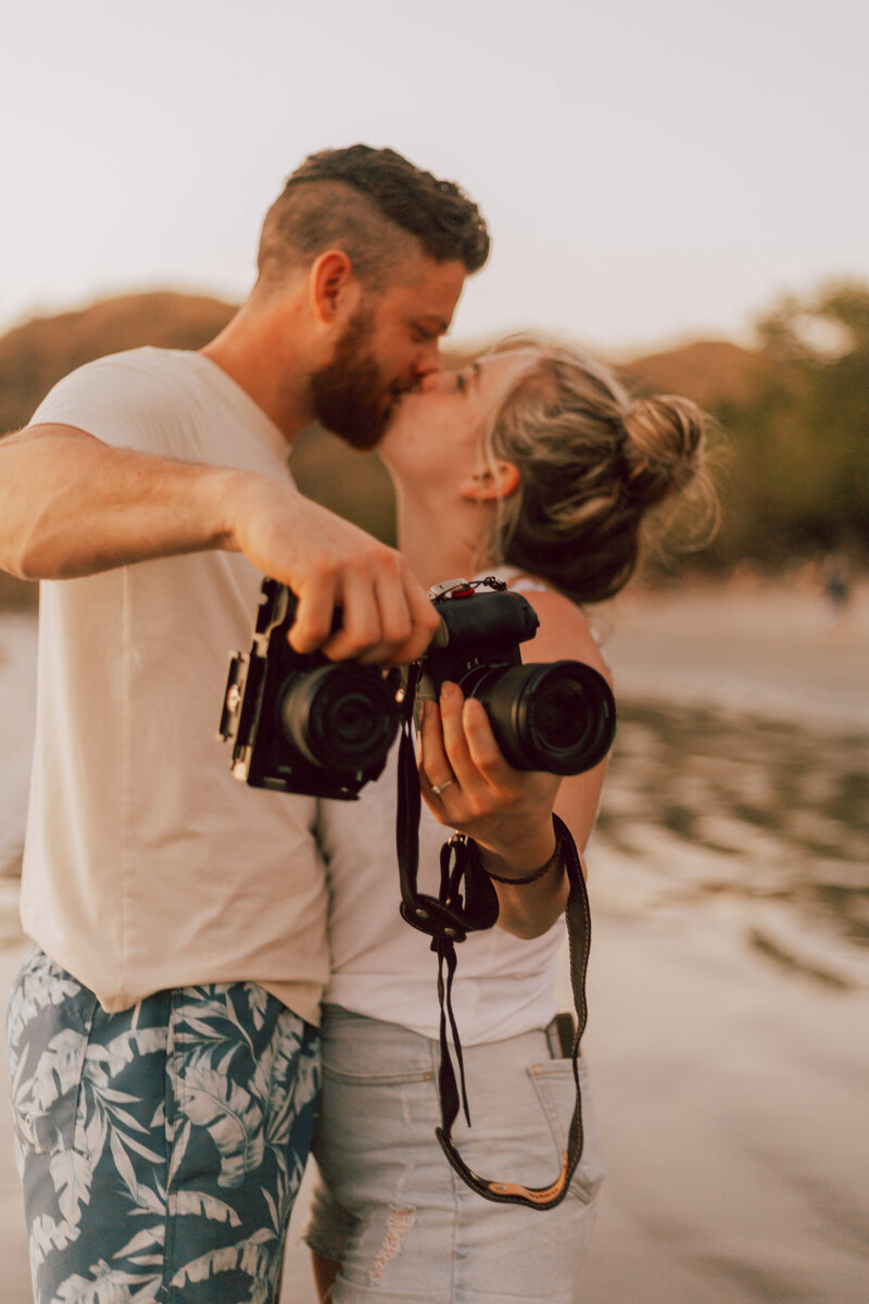Idaho elopement photographers kissing on the beach in Costa Rica.