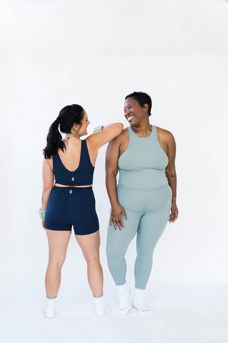 two women smiling at one another