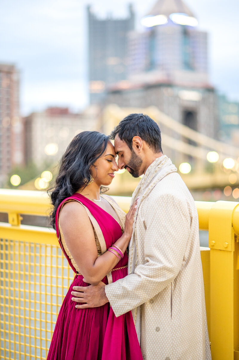 Pittsburgh couple posing on the Roberto Clemente Bridge North Shore