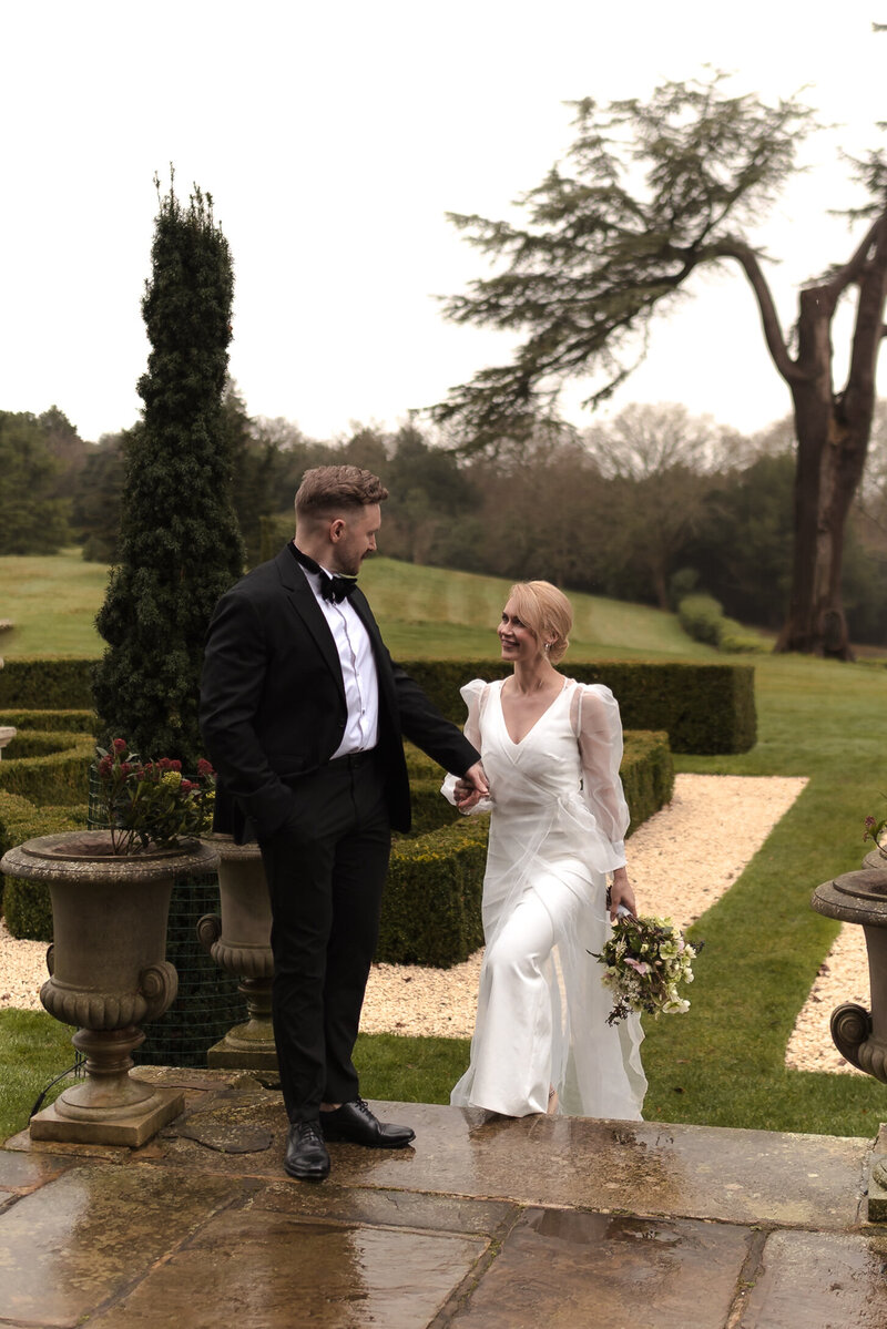 A close angle of a bride admiring her luxury wedding decor at hedor house cotswolds
