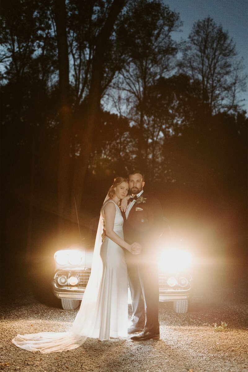 couple standing in front of car