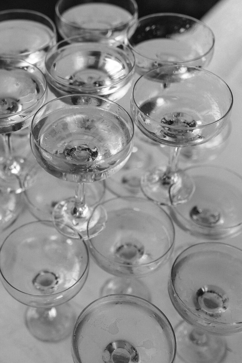 Black and white photo of arranged champagne glasses.