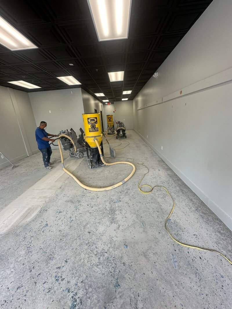A professional from a concrete company working on a commercial site, wearing a branded uniform and utilizing high-quality tools and techniques.