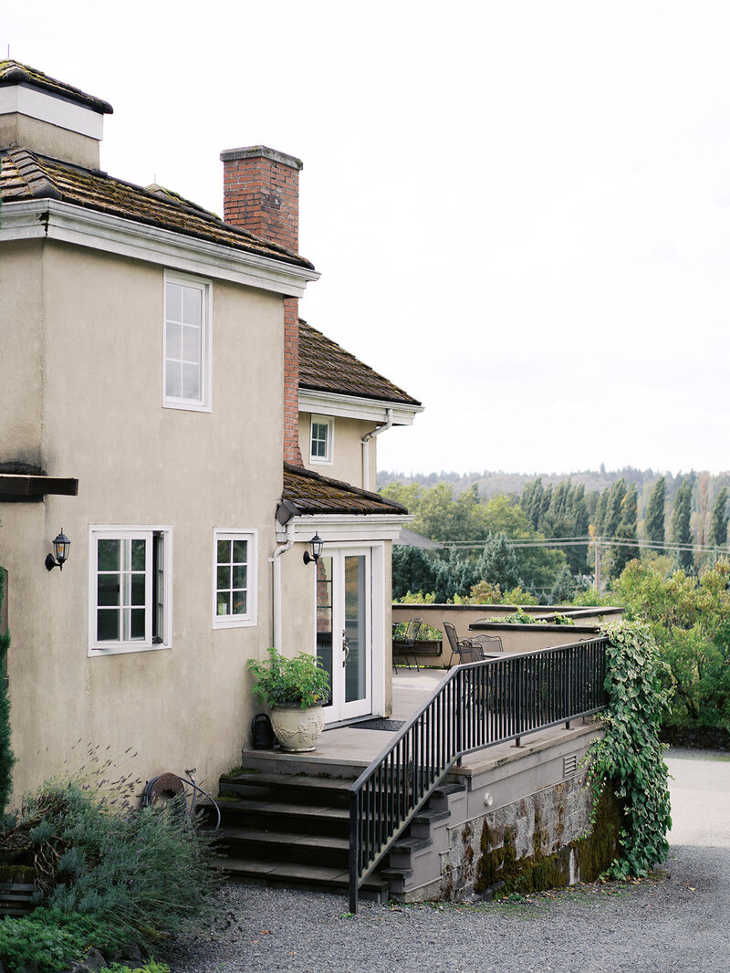 A cozy terrace with elegant outdoor seating and views of the surrounding serene landscapes