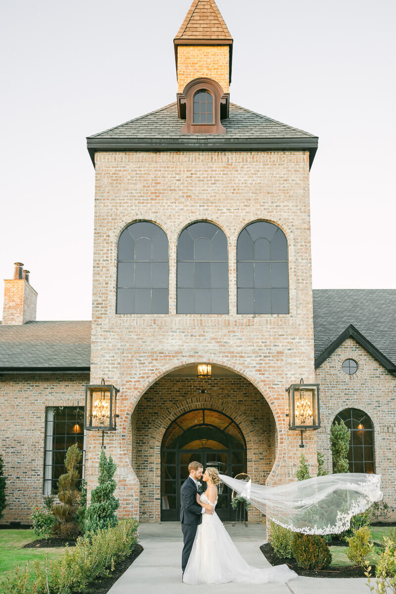 bride and groom standing outside iron manor wedding venue