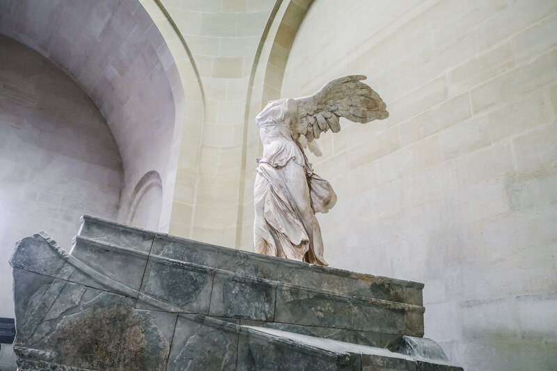 Statue of Winged Victory of Samothrace, a marble statue of a confident headless female figure with wings