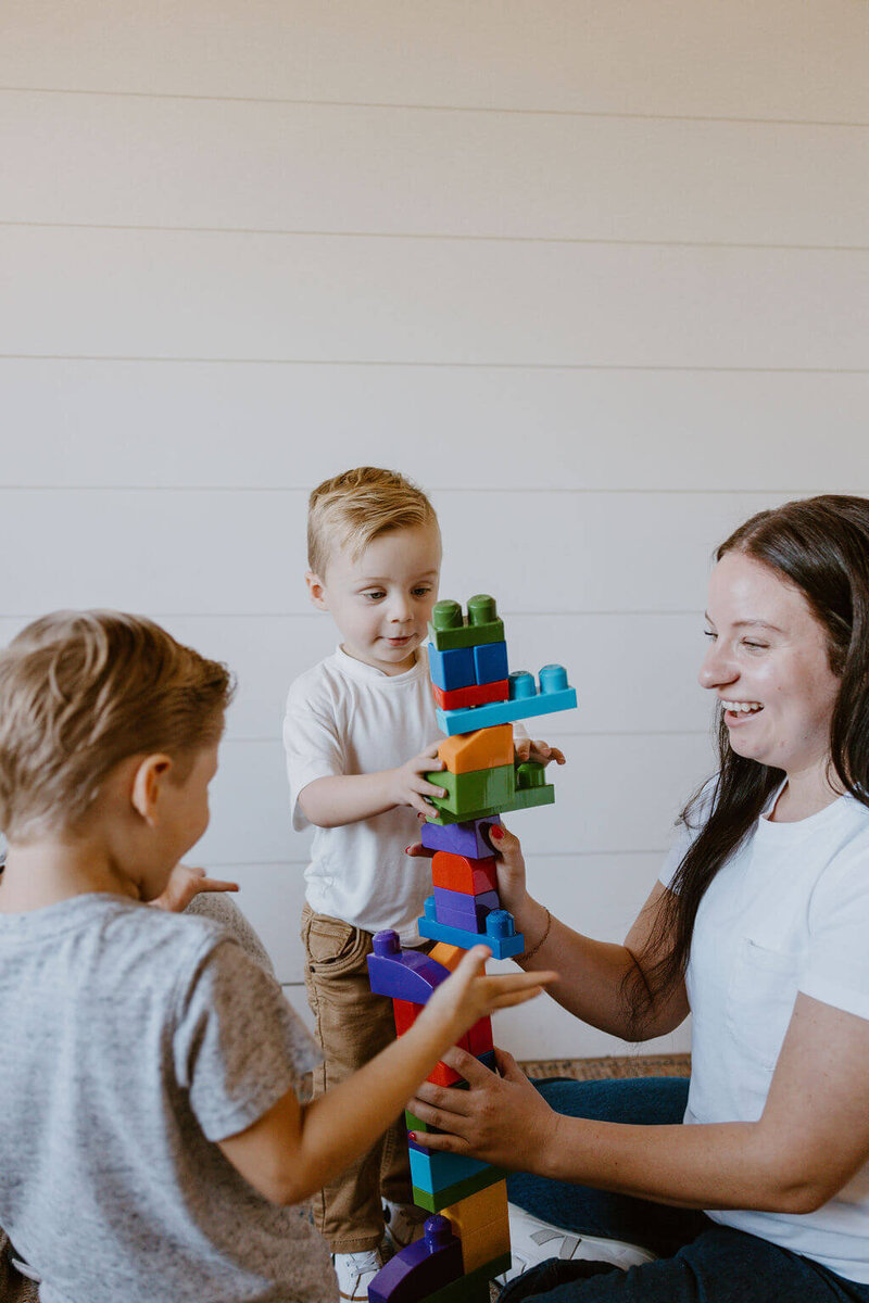 babysitter playing blocks with kids