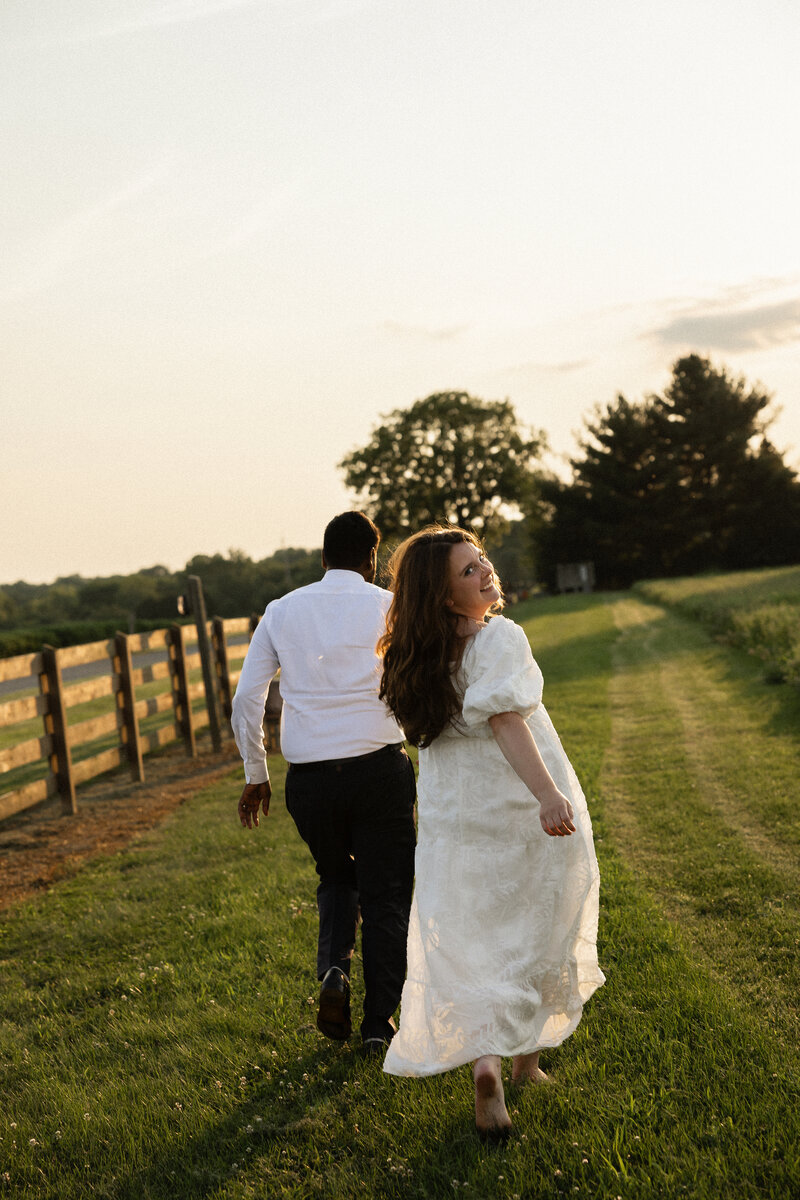 Engaged couple celebrating with a champagne pop during their Kentucky engagement session, laughing and full of joy.