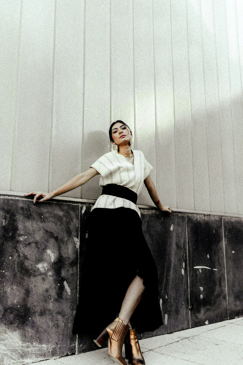 female copywriting, standing against a building with attitude