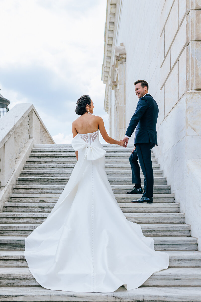 bride and groom walking up stairs