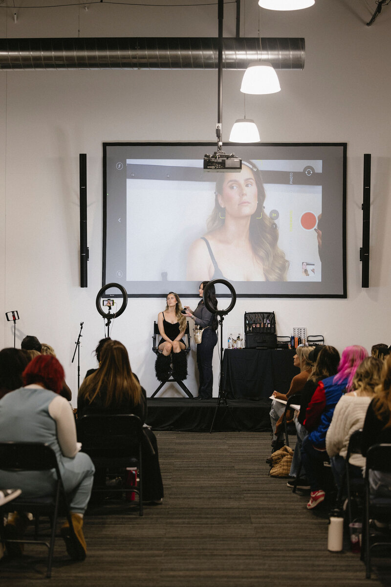 Group of four women standing together and smiling.