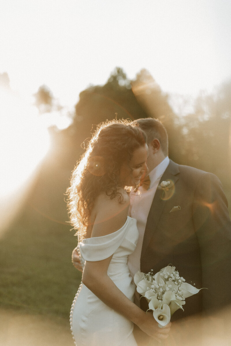 Bride standing in soft golden sunlight, photographed by Jessica from Rainstorm Photo & Video in a dreamy, romantic style.