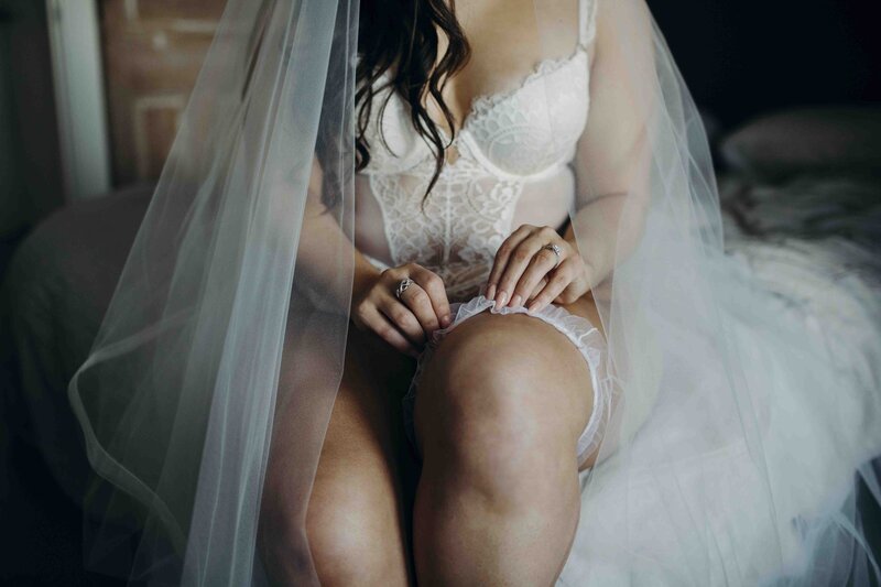 boudoir photo of woman pulling on garter