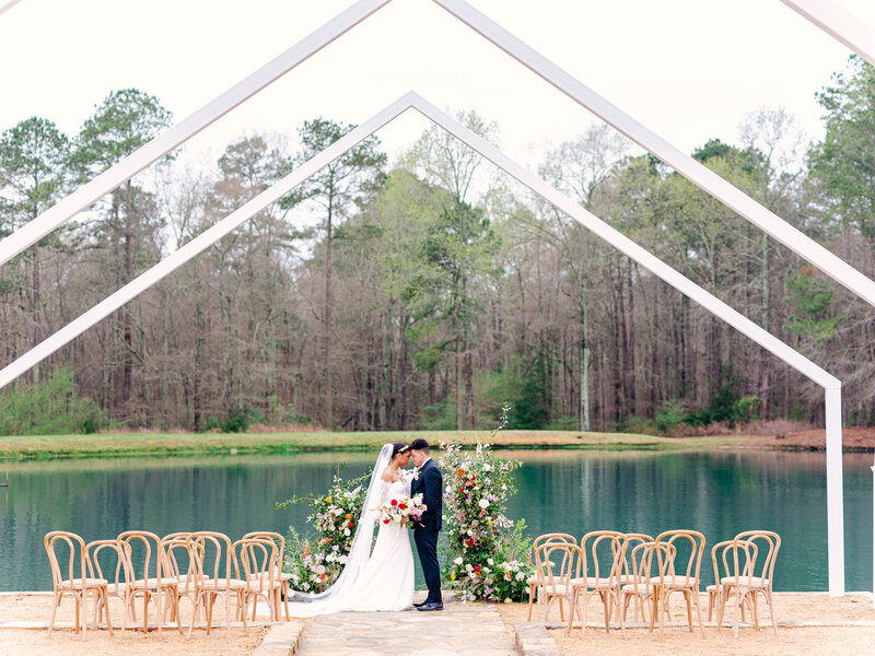 white open air chapel at walnut hill with couple and colorful flower arch