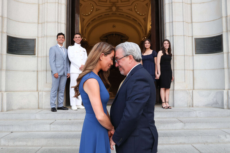 USNA Midshipman in white uniform on the steps of Bancroft Hall for photo by Kelly Eskelsen.